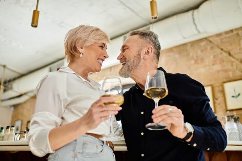 One of the most romantic things to do is have a drink and close conversation with your partner. This couple celebrates by toasting each other.